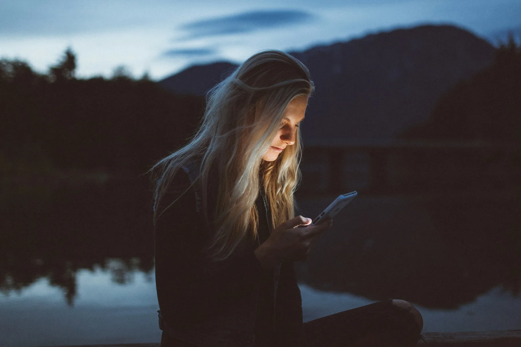 Person using a phone alone at night